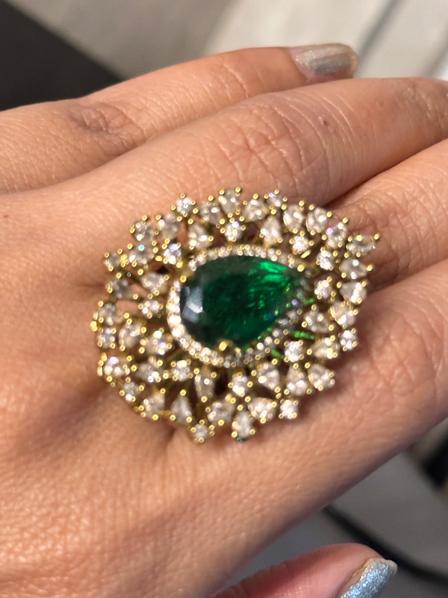 Golden American Diamond Ring with Green Stone as Centerpiece